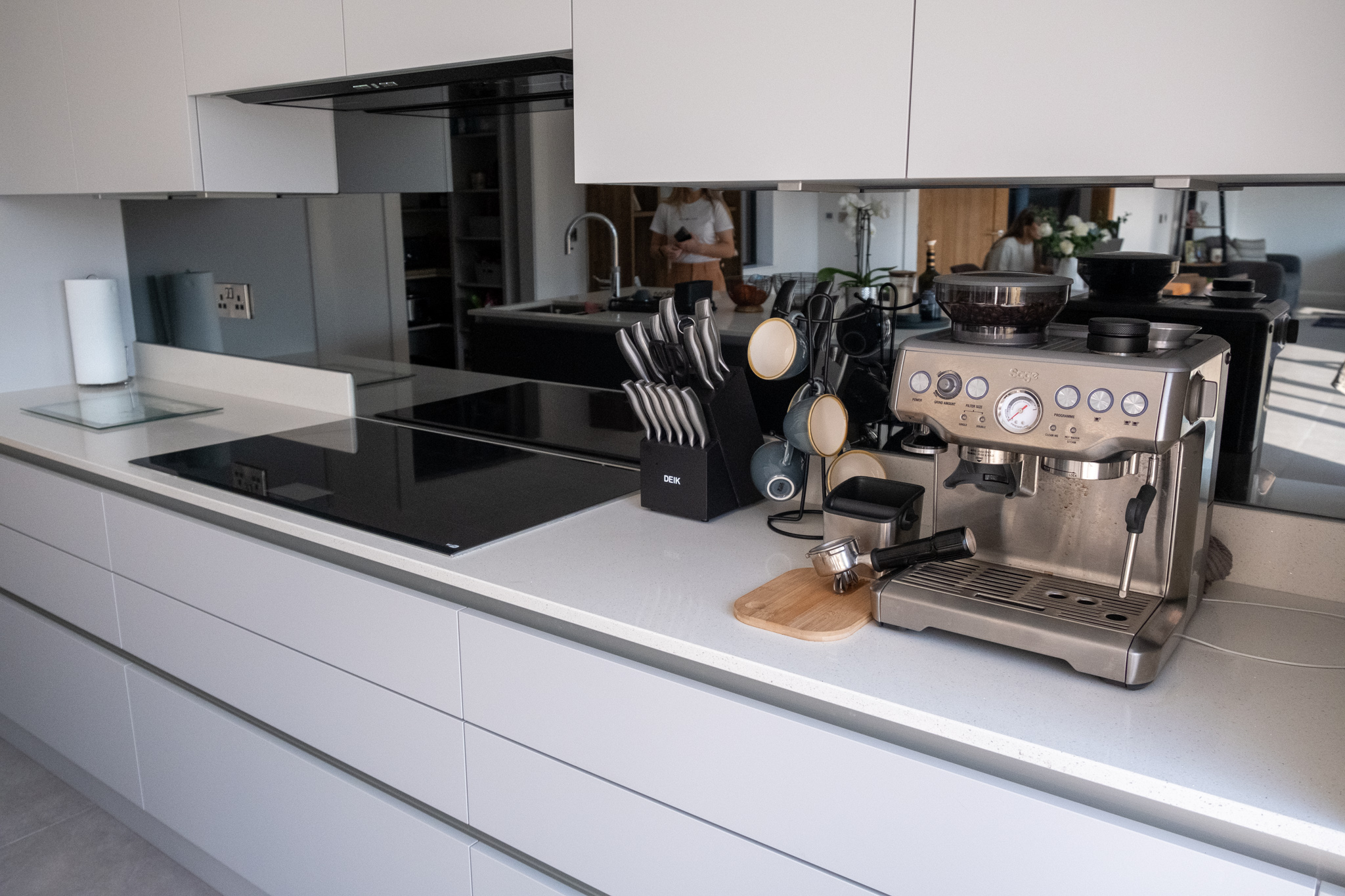 a white kitchen design by torbitts in northern ireland with a copper coffee machine on the counter